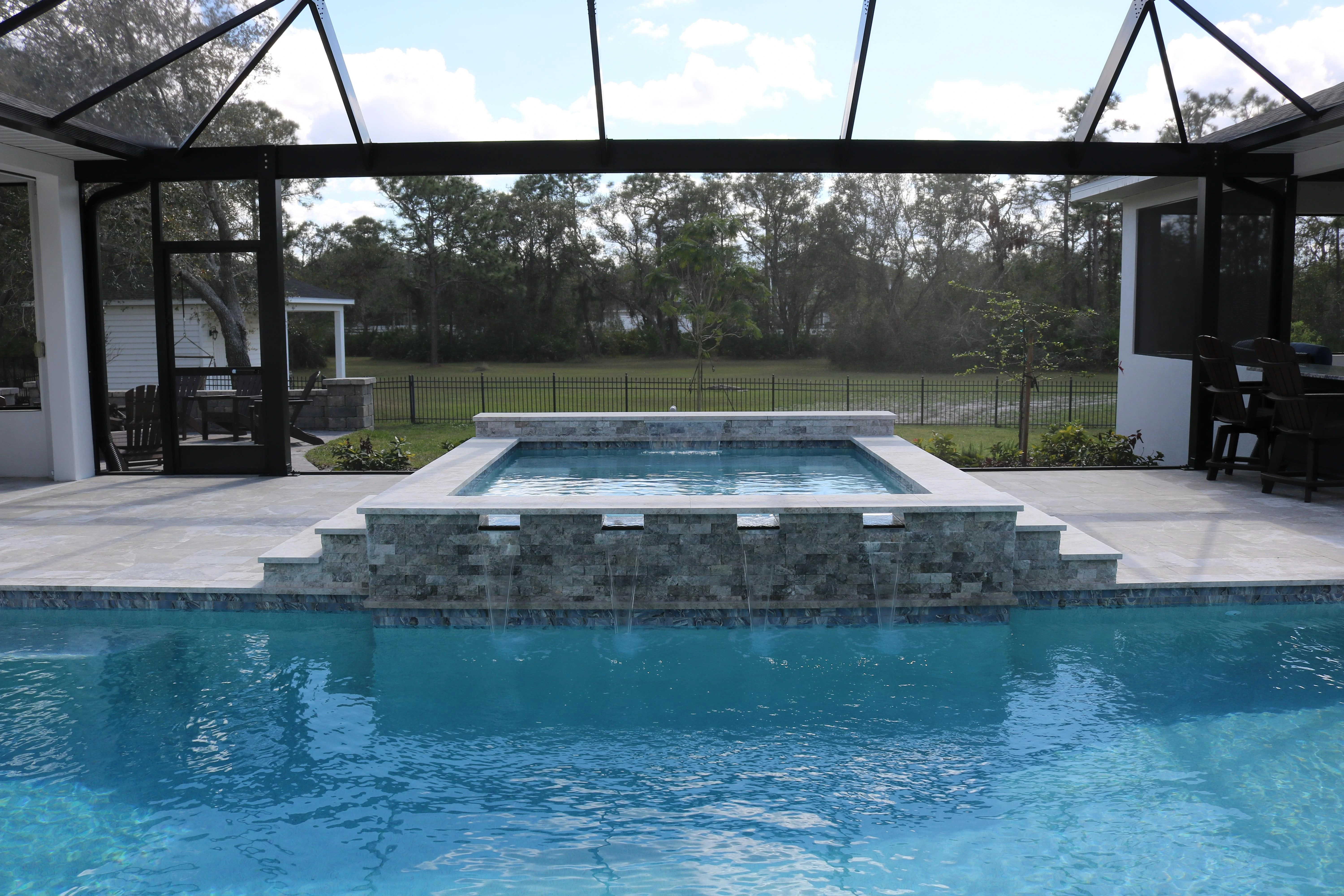 Silver Mist Marble coping and ledgestone completes the look of this spa.