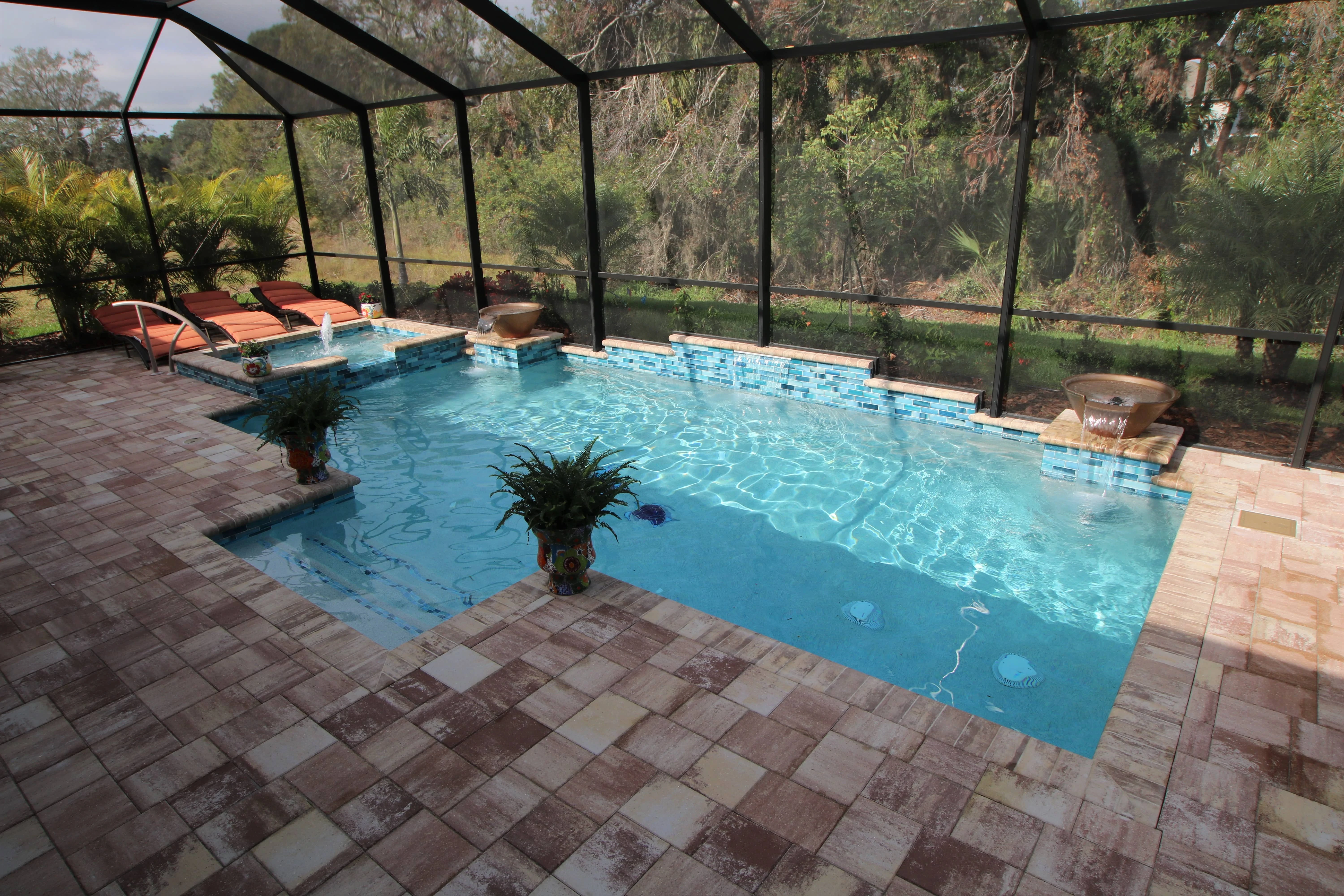 Matching Sand Dune pavers and coping surround this pool accented with GST-2650 blue tile.